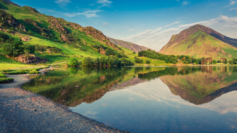 Peaceful lake in Lake District surrounded by hills